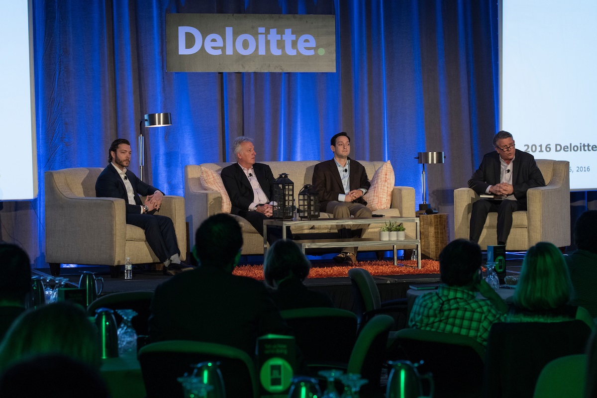 Dustin Muscato (left) on an industry panel stage, 2016